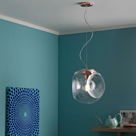 Fabbian Eyes pendant light Ø 35 cm in a modern living space with copper details and a blue background