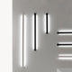 Fabbian Pivot LED-Wandleuchten in Weiß und Schwarz an einer Wand montiert, modernes Beleuchtungskonzept.