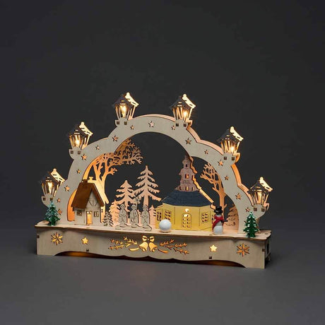 Festive wooden silhouette with church and snowman, battery-operated, brown, in beautiful Christmas decoration.