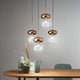 Unica Hängeleuchte Brosilikatglas 4-flammig im modernen Design mit bronzefarbenen Details und eleganten Glaselementen.