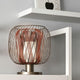 Forestier Tischleuchte Bodyless auf einem Regal, modernes Design mit gewebtem Metall und Diffusor.