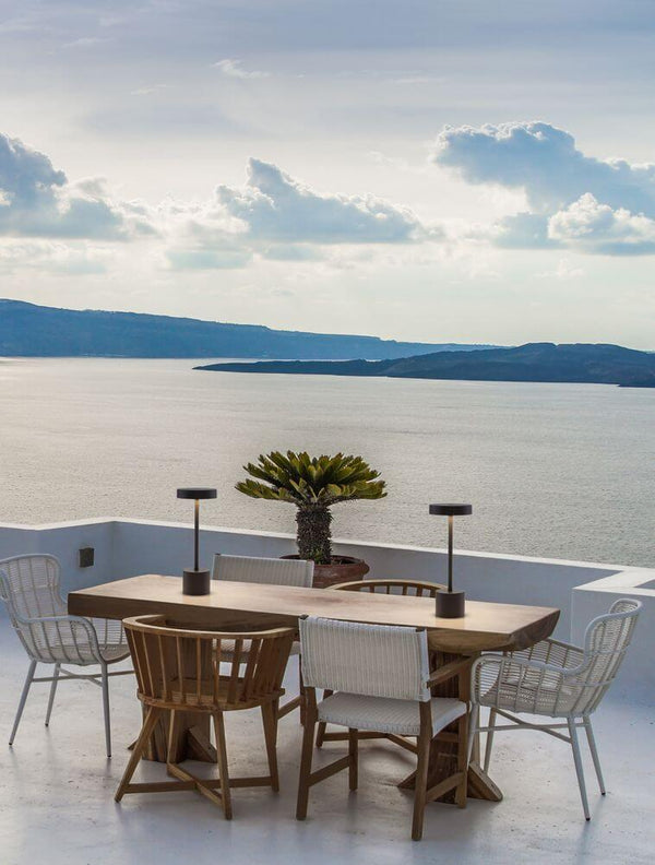 Fumo LED outdoor table lamp 3000K IP54 on a stylish balcony with sea view.