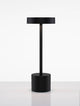 Fumo LED Außentischleuchte 3000K IP54 in elegantem schwarzem Design auf einem Tisch.