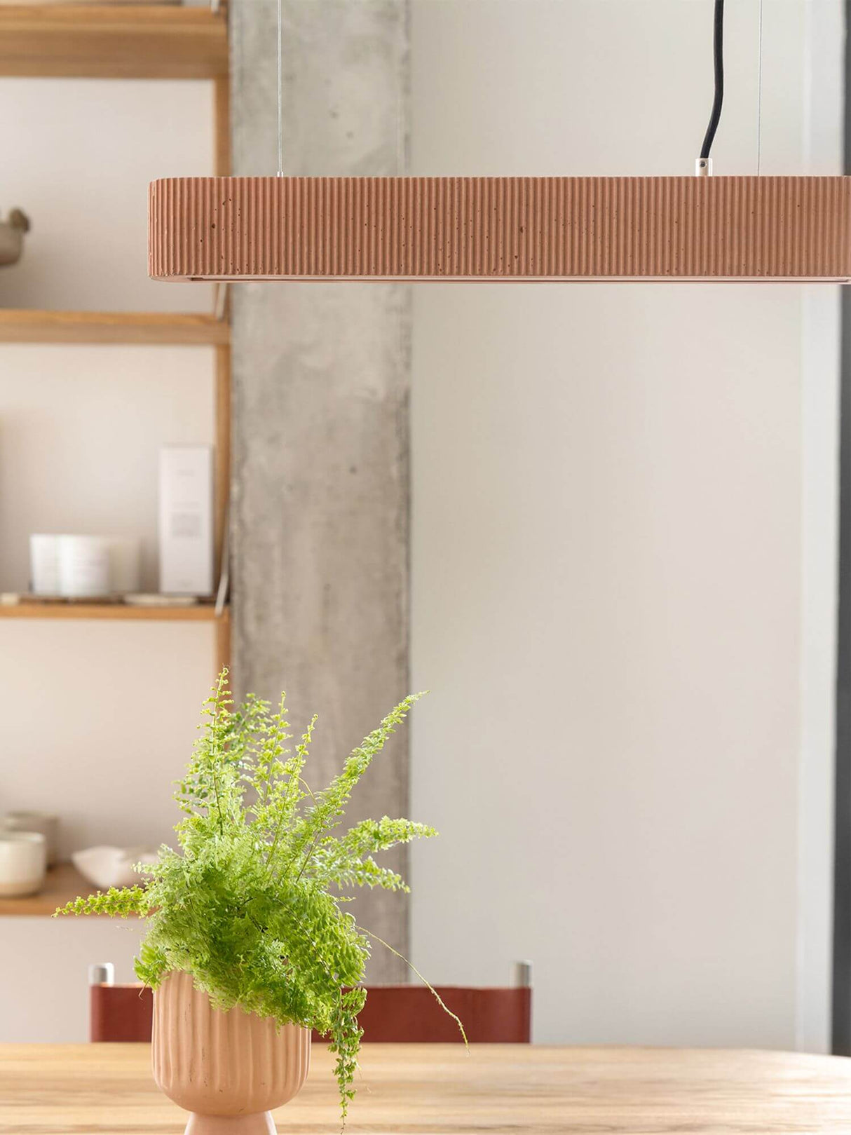 Gantlights S4 Beton LED-Pendelleuchte 61cm Plissiert im modernen Wohnraum mit grüner Pflanze