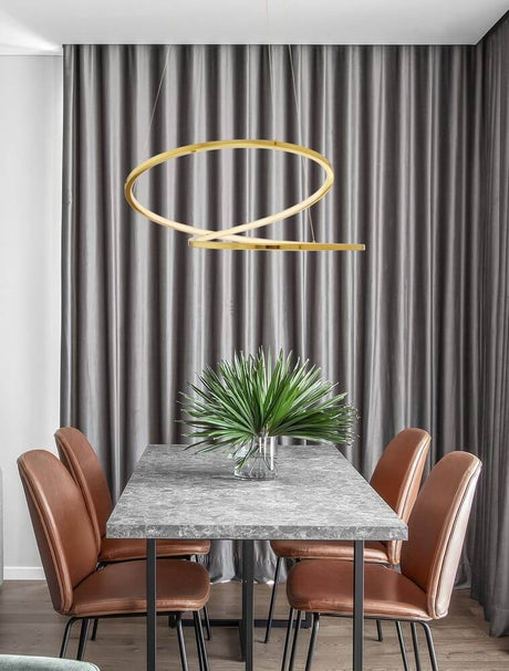 Girish LED pendant light Ø 60cm 3000K gold above a dining table with modern chairs and a plant.
