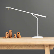 Graceful LED table lamp Flow 5W, 2800-3200K white on a wooden frame, with decorative wooden figures in the background.