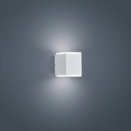 LED Kibo IP54 white outdoor wall light mounted on a wall, with a modern design and soft light.