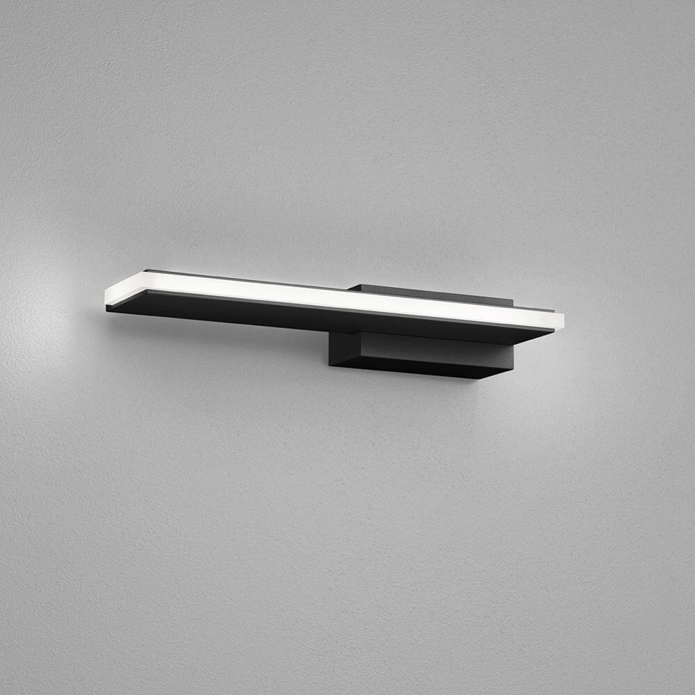 LED Wandleuchte Nex Schwarz an einer Wand, ideal für Flur und Büro.