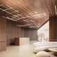 Modern interior view with Panzeri Hilow LED pendant light, wooden ceiling, and minimalist furnishings.