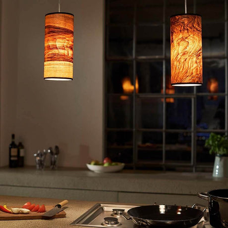 Wooden pendant light Nux Olive ash grain in a modern kitchen setting with warm light.
