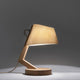Holz Tischleuchte mit Schirm geschwungen in modernem Design, natürliche Materialien, warmes Licht.
