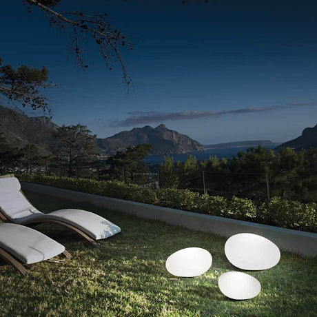 Decorative outdoor light Sasso Pt1 D50 in the garden with beautiful mountain scenery and lake view at night.