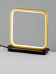 Imar LED Tischleuchte 3200K Schwarz, Gold auf einem Tisch, modernes Design mit warmem Licht.