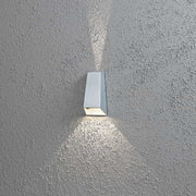 Imola LED outdoor wall light with double beam in grey mounted on a grey wall