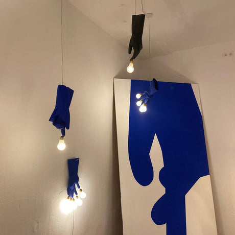 Ingo Maurer LED Hand lamp Luzy Take Five glove with blue rubber gloves and matte LED bulbs.