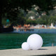 Lampe d'extérieur LED sans fil Pearl avec contrôle par application - deux boules lumineuses placées au bord de l'eau.