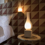 Karman Amarcord wall light in a stylish bedroom with a modern wall light and table lamp.