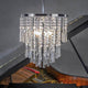 Kronleuchter Luxoria 6-flg. Chrom, Transparent mit modernen Kristallen über Klavier.