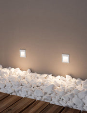 Krypton LED outdoor wall recessed light square light outlet 3000K white IP54 on a wall with white stones.