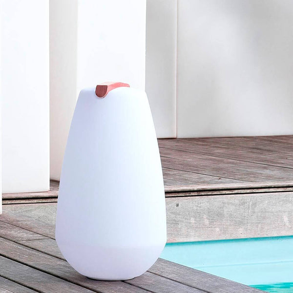 LED Outdoor decorative lamp Vessel 1 battery-operated with app control on a wooden terrace next to a swimming pool.