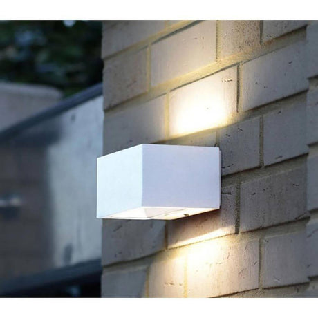 LED Outdoor wall light Gemini IP54 white mounted on a wall, modern design in white.