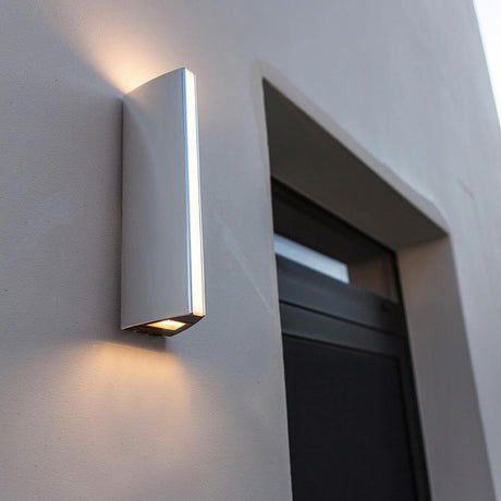 LED Leo outdoor wall light IP44 Chrome mounted on a wall, emits warm white light upwards and downwards.