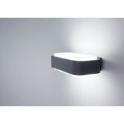LED Außenwandleuchte STICKER IP65 Dunkelgrau an einer Wand installiert mit sanftem Licht.
