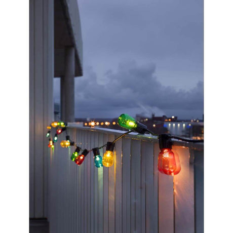LED Beer garden string lights, multicolored, 20 colorful bulbs, 40 warm white diodes, 6V IP44 on a balcony at night.
