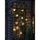 LED Biergartenkette mit 10 klare Birnen Bernstein IP44 um eine Gartenmauer hängend, stimmungsvolles Licht.