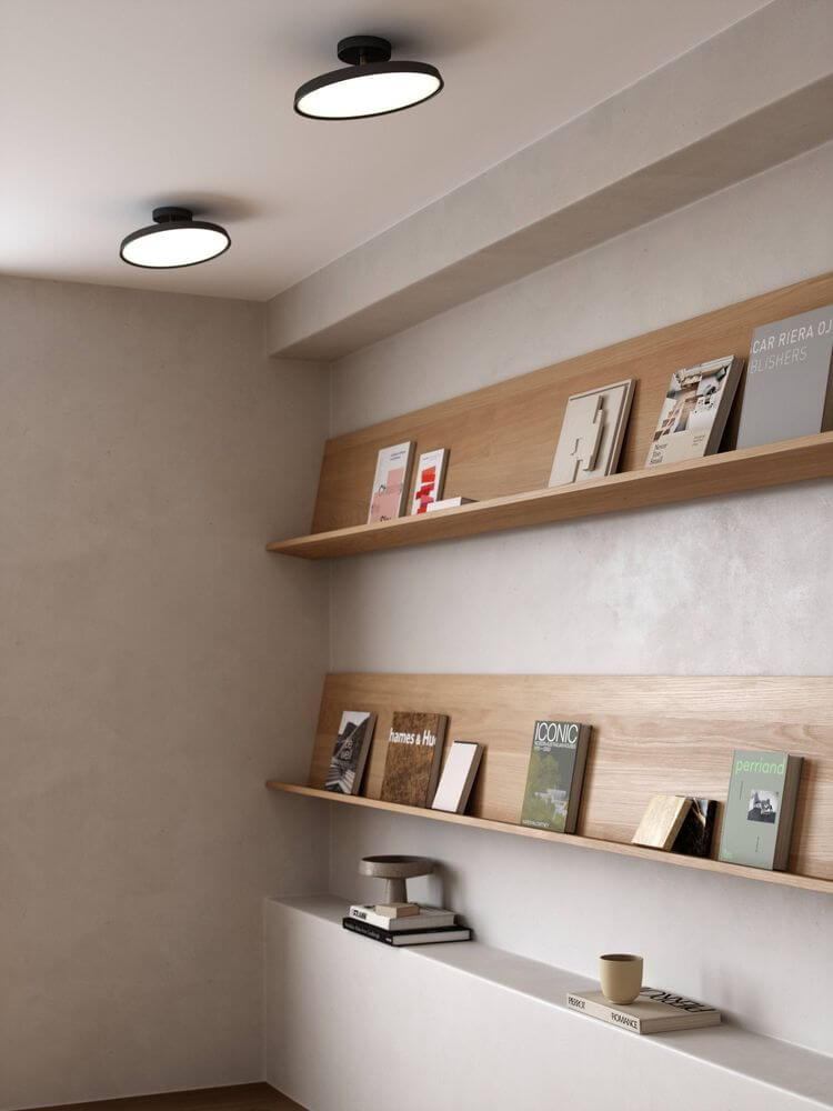 Moderne LED Deckenleuchte Kaito 2 Pro 30 in einem stilvollen Innenraum mit Bücherregal.