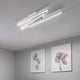 LED Deckenleuchte Linus Sidelong 2520lm Weiß in modernem Raum mit dekorativen Bildern an der Wand.