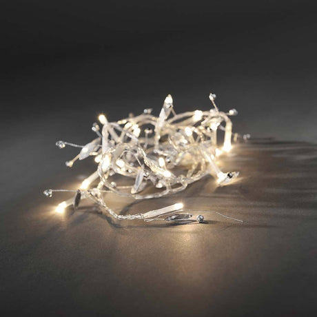 LED Decorative string lights glass beads 20 warm white diodes battery-operated on a dark background.