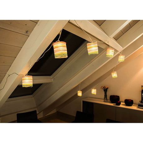 LED Decorative light chain colorful paper lantern 16 warm white diodes in a stylish room with slanted walls and beautiful lighting.