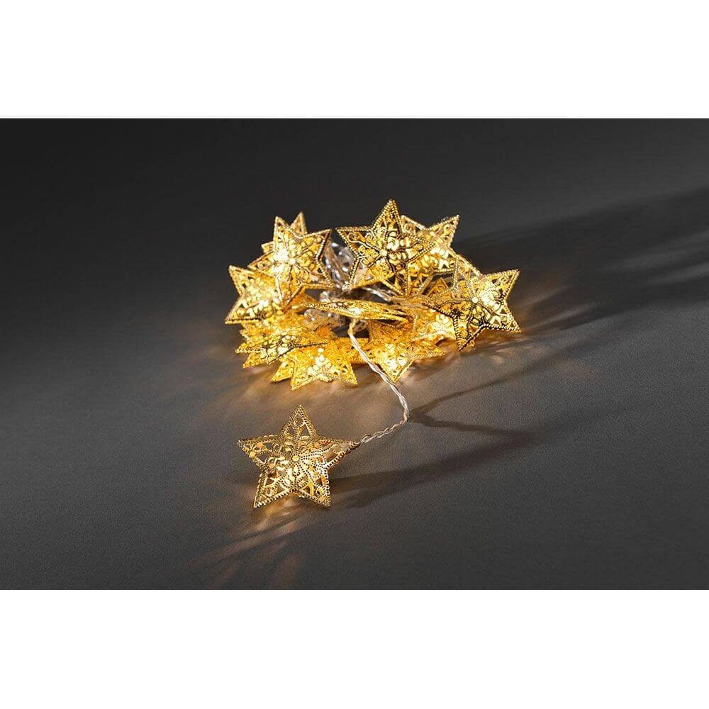 LED Dekolichterkette goldfarbene Metallsterne 16 Warmweiße Dioden auf einem dunklen Hintergrund
