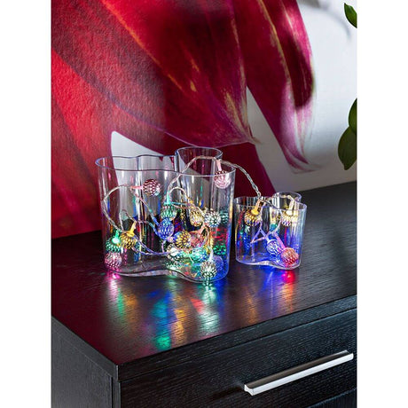 LED Decorative string lights with silver-colored metal balls, 21 colorful diodes in glasses decorated on a table.