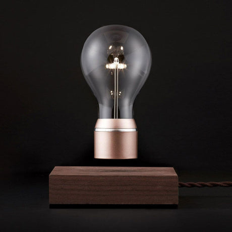 LED-decorative table lamp floating light bulb with Edison design made of borosilicate glass and oak wood base.