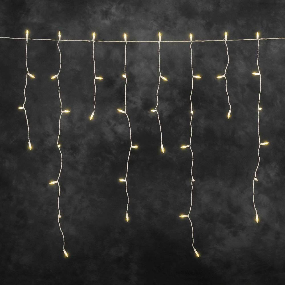 LED Eisregen Lichtervorhang 200 bernsteinfarbene Dioden 31V IP44 mit warm-weißen Lichtpunkten auf dunklem Hintergrund