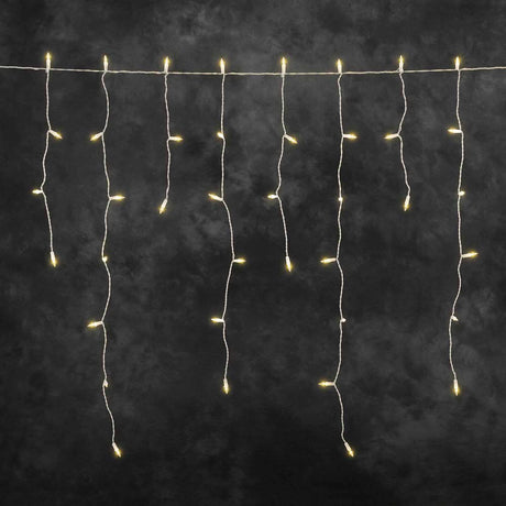 LED Eisregen Lichtervorhang 200 bernsteinfarbene Dioden 31V IP44 mit warm-weißen Lichtpunkten auf dunklem Hintergrund