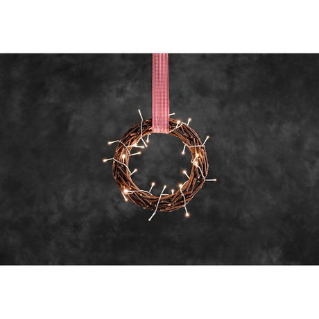 LED Wooden silhouette wreath brown with red-and-white fabric ribbon, 30 warm white diodes, decoratively illuminated on a dark background.