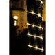 LED Mini Lichterschlauch 10m mit Lichtsensor Timer 130 Warmweiße Dioden batteriebetrieben IP44 um einen Baum gewickelt.