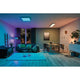 LED Panel Smart Home Zigbee Amaris Eckig RGBW Weiß-Matt in modernem Wohnzimmer mit stimmungsvollem Licht.