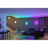 Modernes Wohnzimmer mit LED Panel Velora Rainbow, farbenfrohe Beleuchtung und stilvoller Einrichtung.