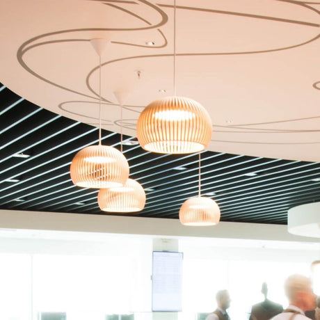 LED Atto 5000 wooden pendant light Ø 34 cm in modern, stylish spaces with wooden slats.