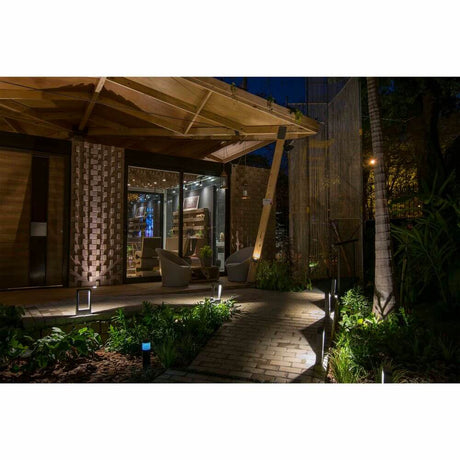 LED Base light DAS 8W 3000K 30cm IP54 dark grey illuminated outdoors at night.