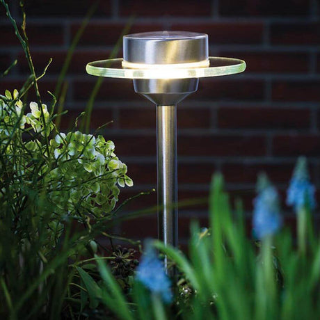 LED Ufo solar spike IP44 stainless steel in the garden with flower lighting at night.