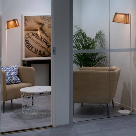 LED Owalo 7010 floor lamps made of wood, 168 cm, in a modern living environment with a cosy seating area.