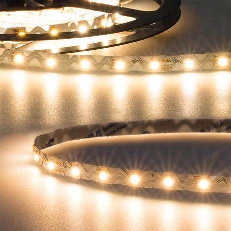 LED-Strip 5m flexibel für Ecken und Kurven 24V 950lm/m Warmweiß mit warmweißem Licht auf einer Oberfläche.