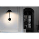 LED Lese-Wandlampe PURE 6W 3000K Schwarz an einer Wand montiert mit sanfter Beleuchtung.