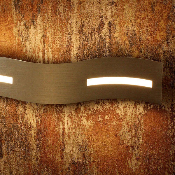 LED Wandlampe Wave Nickel-Matt, Chrom an einer dekorativen Wand aus rostigem, strukturiertem Material.