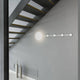 LED Wandleuchte HAN Schwarz Garderobenhaken in modernem interieur, beleuchtet eine Treppe.